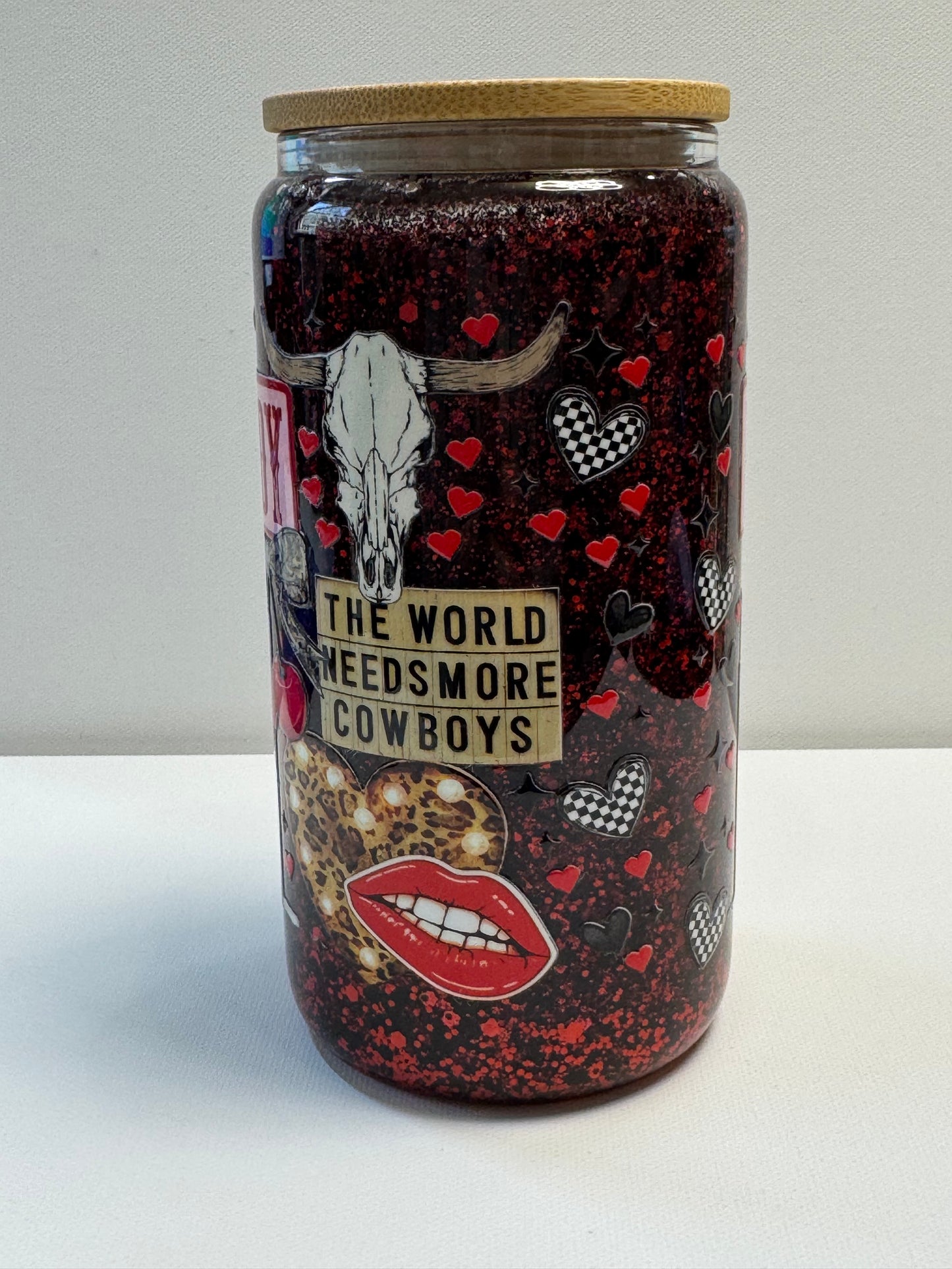 16oz Glass snow globe w/red&black glitter suspended flow. Western