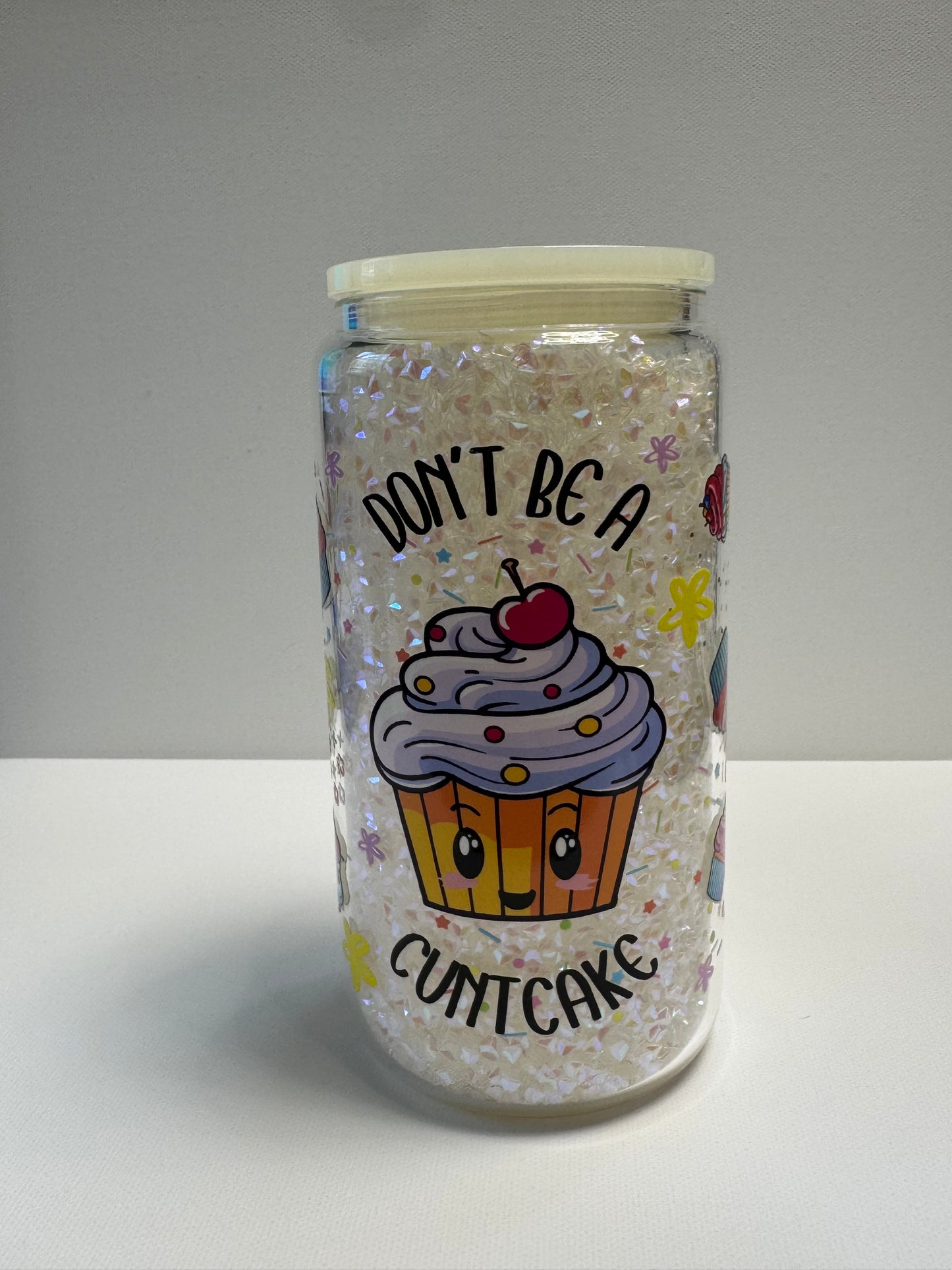 16oz Glass snow globe with sassy wrap and filled with white gems.